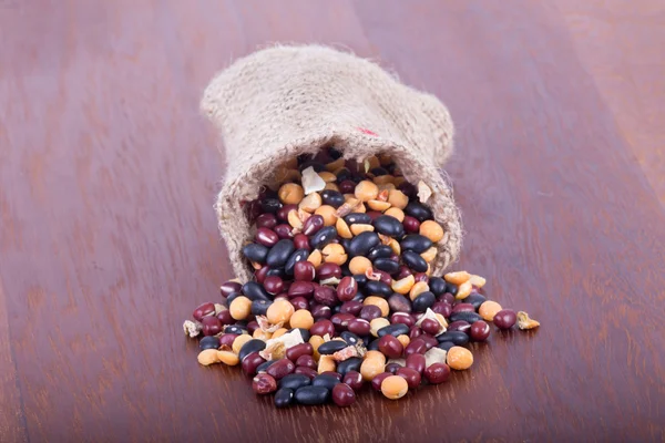 Grains in the sack on the table — Stock Photo, Image