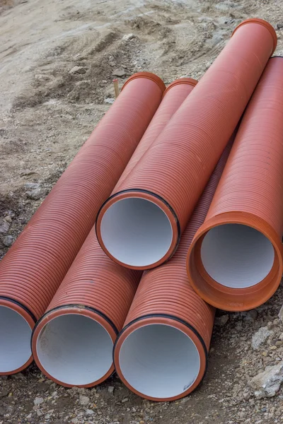 Underground orange plastic pipes — Stock Photo, Image