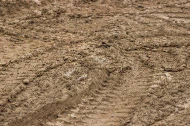 Tire tracks in the mud, dirty road background clipart