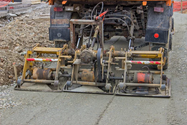 Plate compactor mounted on truck compacting gravel 2 — Stock Photo, Image