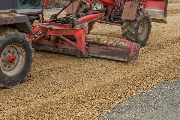 Close up of motor grader working on gravel leveling — Stock Photo, Image