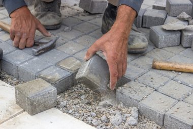 laying concrete brick pavers clipart