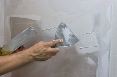 Man hand with trowel plastering a wall 2 clipart