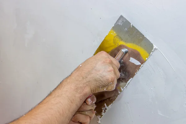 Man hand with trowel plastering a wall 4 Stock Picture