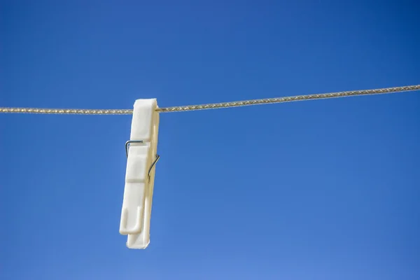 Single clothesline peg on line — Stock Photo, Image