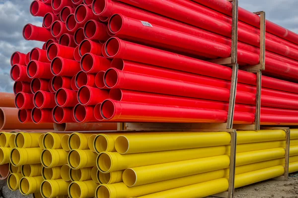 Stacks of various colored pvc water pipes — Stock Photo, Image