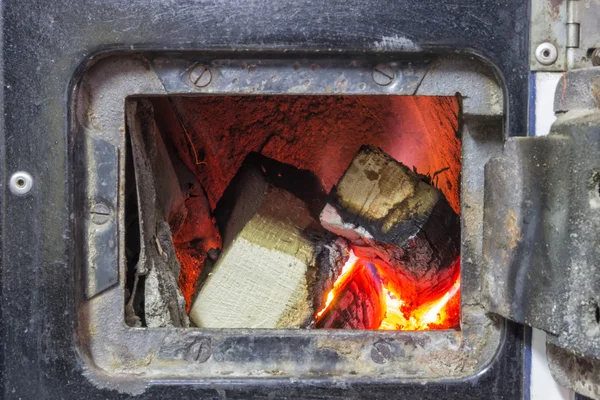 Wood stove firebox with fire and wood — Stock Photo, Image