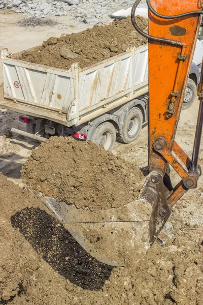 Excavator arm with bucket full of dirt Stock Image