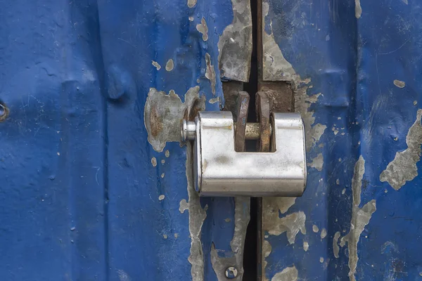 Locked padlock on metal door — Stock Photo, Image