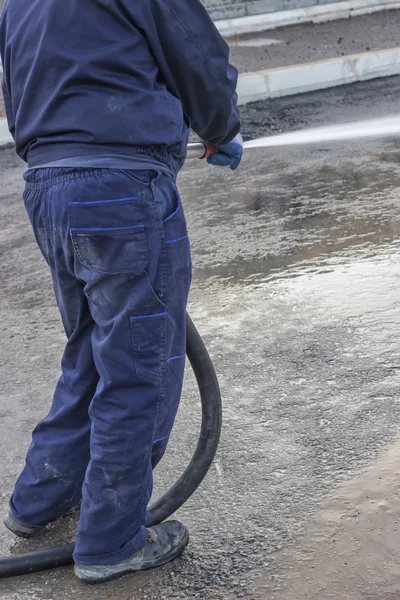 Using water hose to clean road 3 — Stock Photo, Image