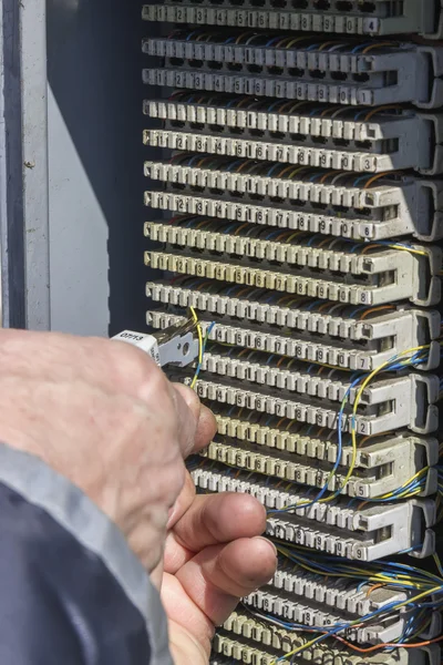 Close of hand punching down circuit panel 2 — Stock Photo, Image