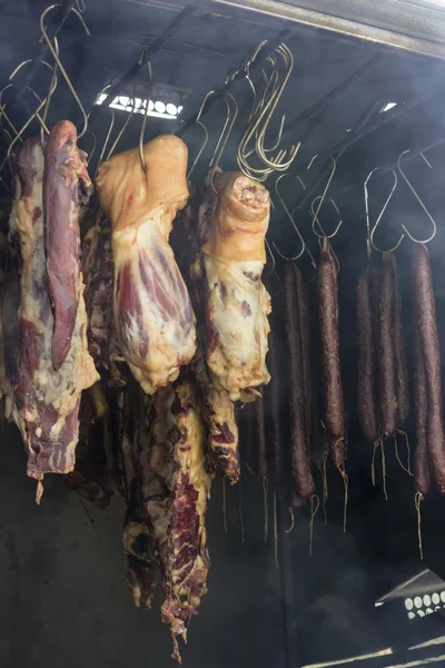 Meat and sausages hanging in smokehouse 2 — Stock Photo, Image
