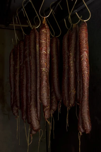 Smoked sausages hanging in smokehouse — Stock Photo, Image