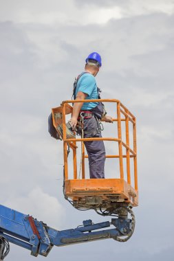 Electrical worker in lift bucket 2 clipart