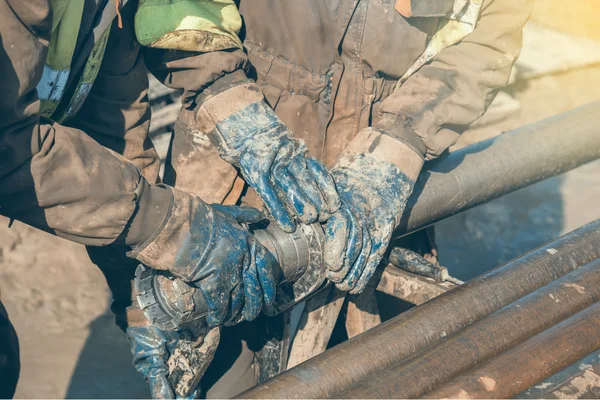 Worker hands checks a diamond core drill bit 2 — Stock Photo, Image