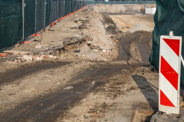 Earth road entrance to construction site — Stock Photo, Image