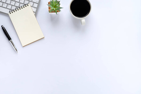 White office desk table with keyboard, notebook and coffee cup with equipment other office supplies. Business and finance concept. Workplace, Flat lay with blank copy space. Top view