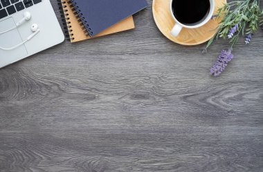 Üzerinde klavye, klavye, kahve fincanı, defter, fare bilgisayarı, ekipman ofis malzemeleri olan koyu renk ahşap ofis masası. İş finans konsepti. Çalışma yeri, boş kopya alanı olan düz uzanma.