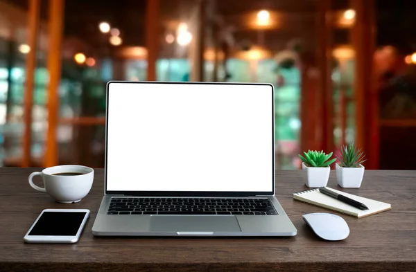 Front view of open laptop computer notebook with blank monitor white screen display on work table desk. Workspace office modern for job business online communication technology in shop or home indoor.