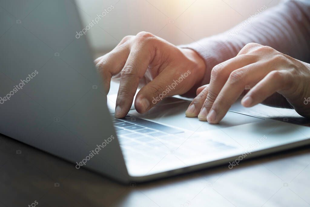 Close-up of man hands using and typing keyboard of laptop computer on office desk. Workspace, businessman working project creative idea for job online network. Business finance and technology concept.