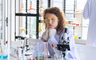 Laboratuvarda kimyasal araştırma yapan genç bilim adamları ya da araştırmacılar. Bilim adamları yeni bir ilaç ya da aşı keşfetti.