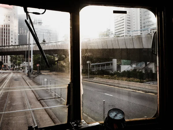 Vew from the old tram to the empty city on a sunny morning. Hong Kong. Vintage toned