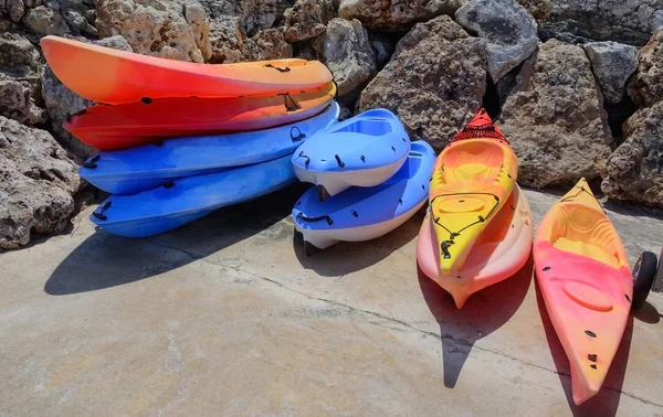 Stacks of colorful kayaks — Stock Photo, Image