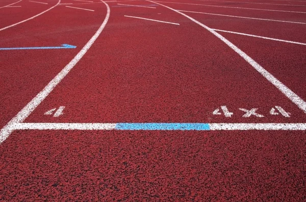 Red running field track with arrows and lines