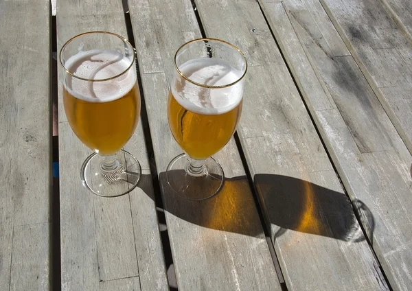 Два пива на сільському дерев'яному столі — стокове фото