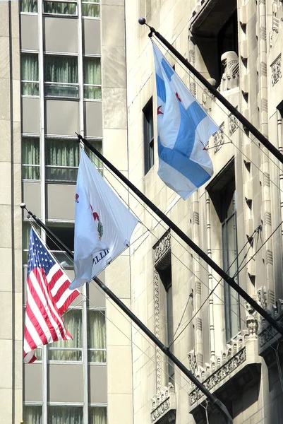 American and local state flags flying outside government building — Stock Photo, Image