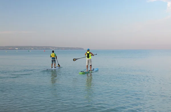 Two paddle board surfers at dawn — Stock Photo, Image