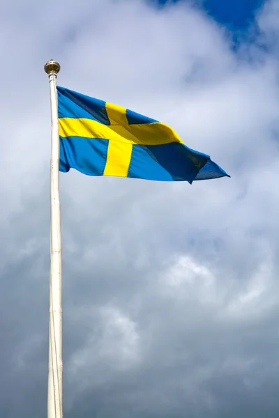 Zweedse vlag tegen storm grijze luchten — Stockfoto