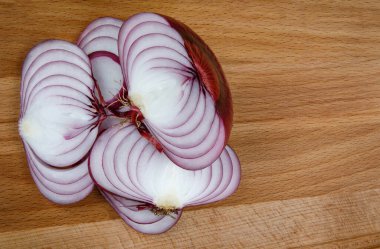 Cut juicy salad onions on a wooden board close-up. wooden background.