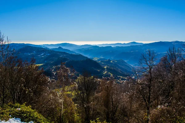 panorama of the Venetian hills among the mists of the plain taken from the pre-alps above Valdagno, Vicenza, Italy