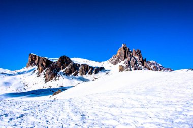 peaks of the Dolomites with snow, alpine valleys blue sky white clouds, snow tracks in the Zoldo valley, Belluno, Italy clipart