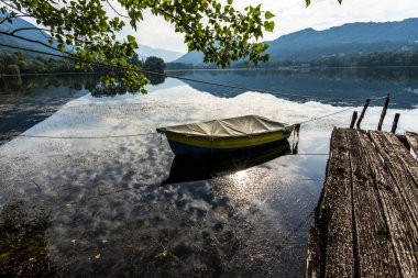 Mavi ve sarı ahşap tekne Revine Lago Treviso Venedik İtalya 'da muşambayla kaplıydı.