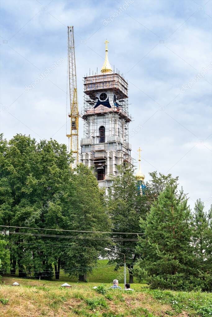 Russia  Kostroma  July 2020. Construction crane near the bell tower of the Orthodox Cathedral under construction.