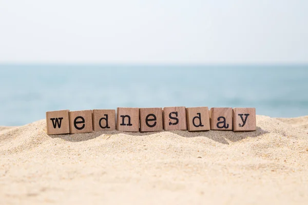 Wednesday word on seaside — Stock Photo, Image