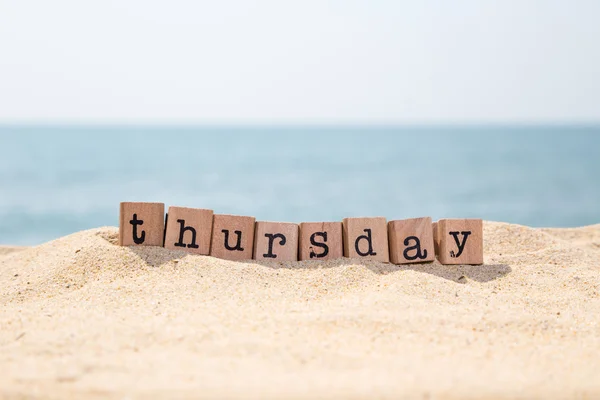 Thursday word on sand and seaside — Stock Photo, Image