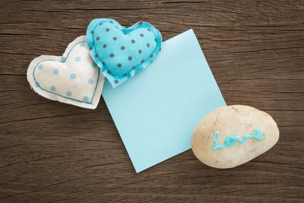 Sweet love hearts and blue blank paper on wood — Stock Photo, Image