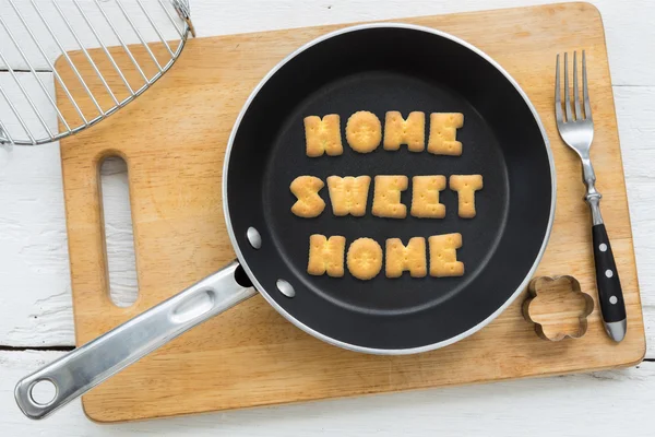 Letter biscuits quote SWEET HOME and cooking equipments. — Stock Photo, Image