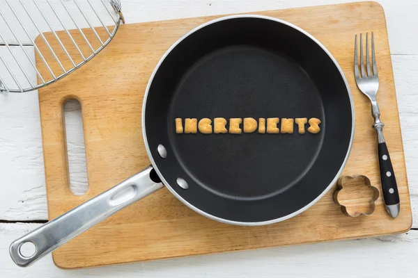 Letter biscuits word INGREDIENTS and cooking equipments. — Stock Photo, Image