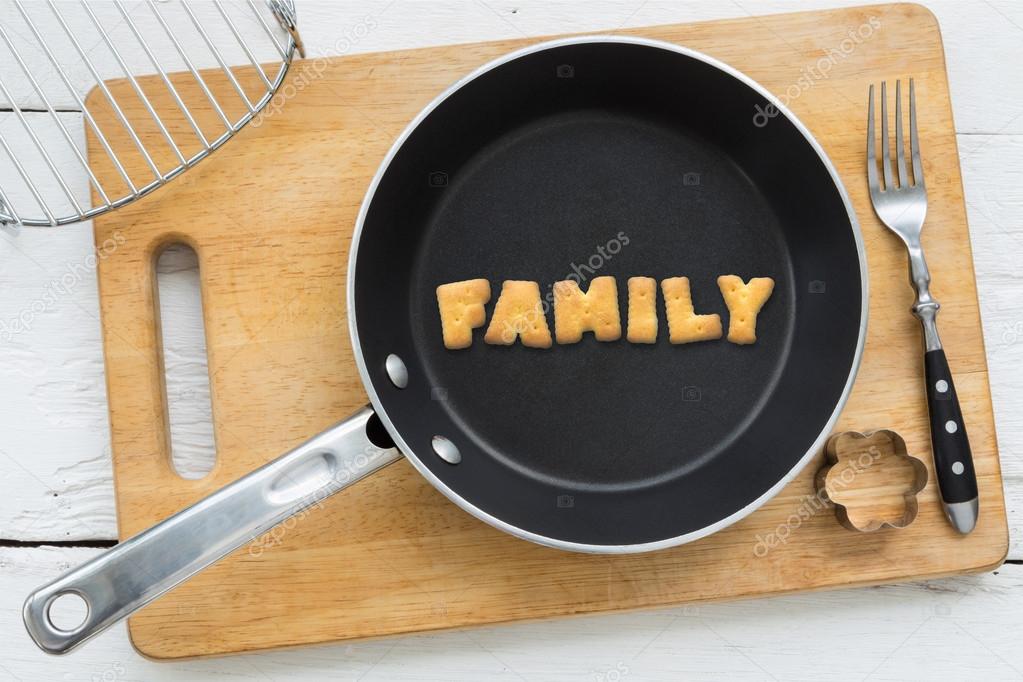 Letter biscuits word FAMILY and cooking equipments.