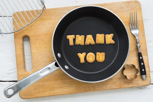 Cookie biscuits word THANK YOU in frying pan — Stock Photo, Image