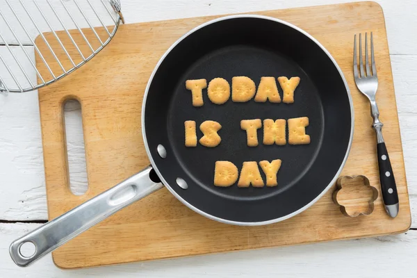 Cookie biscuits quote TODAY IS THE DAY in frying pan — Stock Photo, Image