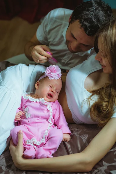 Image of young caucasian family indoor. Father, mother and cute little girl — Stock Photo, Image