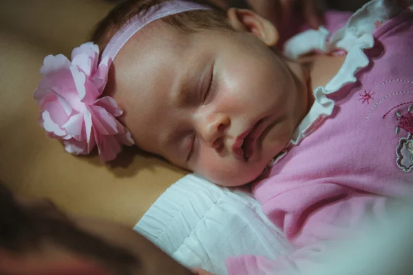 Image of cute little girl in pink suit indoor. Newborn baby — Stock Photo, Image