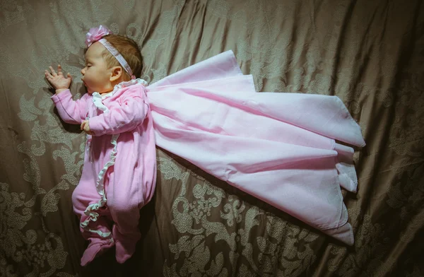 Изображение милой маленькой девочки в розовом костюме и плаще внутри — стоковое фото