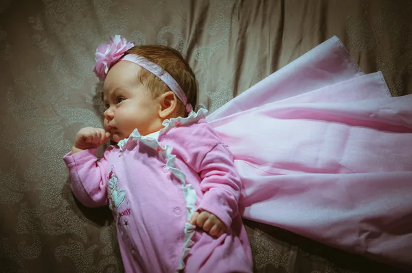 Image of cute little girl in pink suit and cloak indoor — Stock Photo, Image