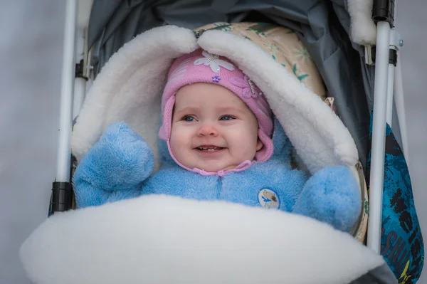 Smiling baby sitting in sledge. Happy infant girl — Stock Photo, Image